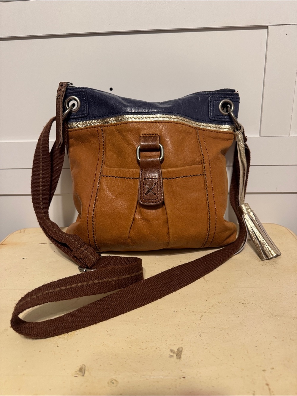 The SAK Kendra Leather Crossbody Bag in Brown and Navy with Gold Trim